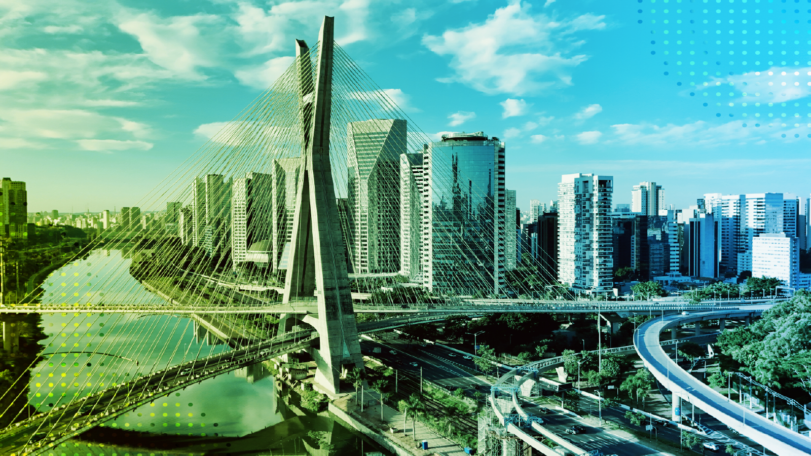 Modern bridge and skyscrapers in São Paulo, Brazil, with a blue sky and urban river view.
