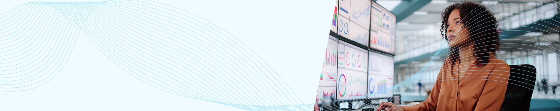 Professional woman in a brown blouse analyzing data dashboards displayed on multiple large monitors, with abstract blue wave patterns overlaying the banner.