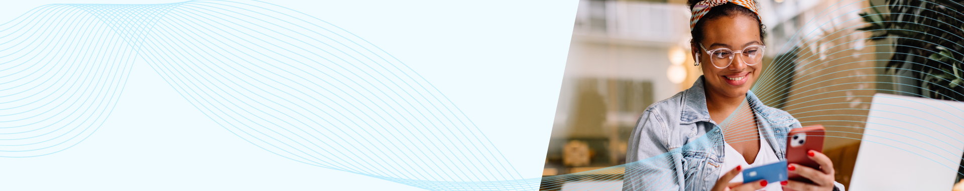 Smiling professional holding a smartphone and a credit card while seated at a laptop, with abstract blue wave patterns flowing across the banner.