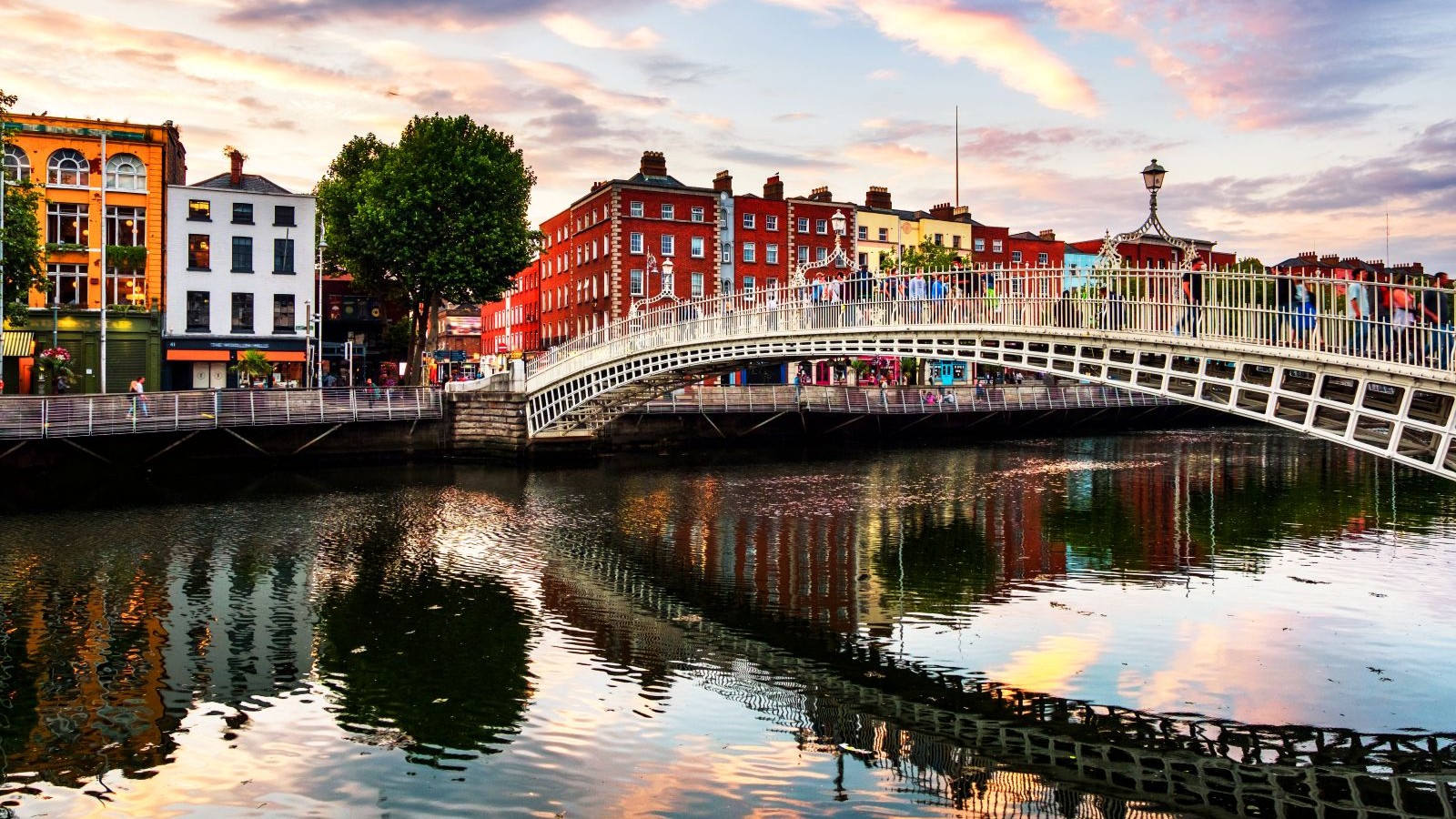 Dublin’s Ha’penny Bridge over the River Liffey at sunset.